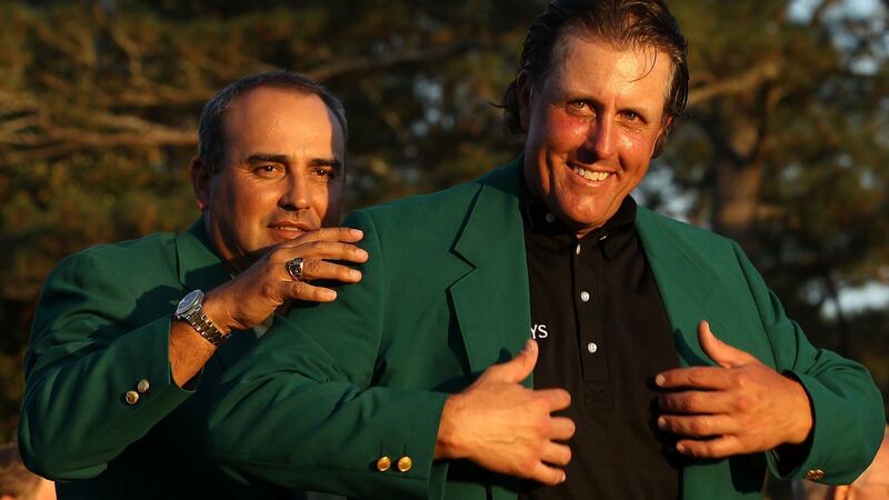 Angel Carbrera presents Phil Mickelson with his green jacket after his win in 2010. Photograph: Streeter Lecka/Getty Images for Golf Week