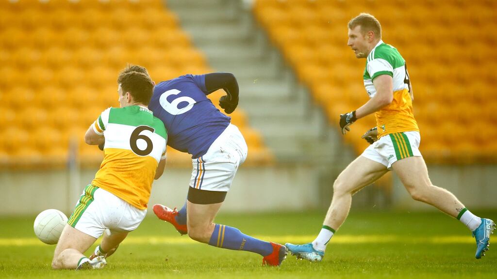 Longford’s Michael Quinn scores his goal despite the attentions of Shane Nally and Niall Darby. Photo: James Crombie/Inpho