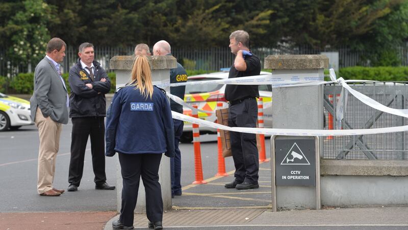 Gardaí at the cordoned-off scene of a shooting outside Lidl on the Blakestown Road, Mulhuddart, on Saturday evening. Photograph: Alan Betson