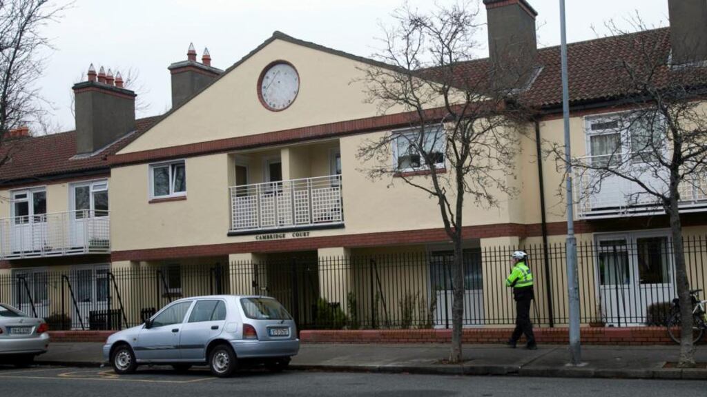A garda stands outside  Cambridge Court in Irishtown, Dublin 4 where  Thomas Horan was murdered earlier this week. Photograph: Collins Photos