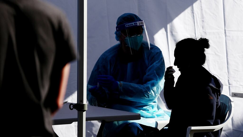A healthcare worker wearing conducts a Covid-19 swab test, Sydney, Australia. Photograph: Brendon Thorne/Bloomberg