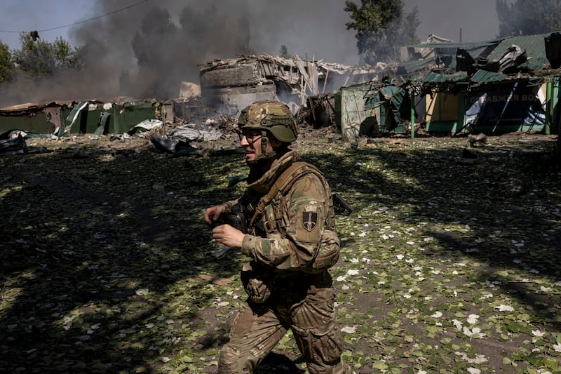 A Ukrainian soldier runs past the site where a Russian glide bomb exploded minutes earlier near the embattled city of Pokrovsk. Photograph: Finbarr O’Reilly/The New York Times