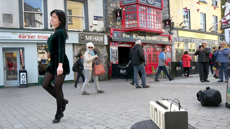 Dancer Emma O’Sullivan performs to music from her small amplifier while busking in Galway city centre. Photograph: Joe O’Shaughnessy