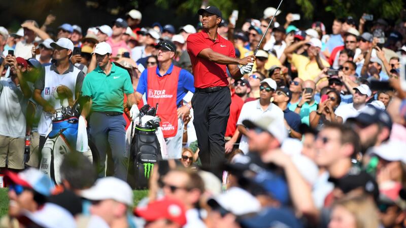 Tiger Woods plays his shot from the ninth tee during the final round of the Tour Championship.