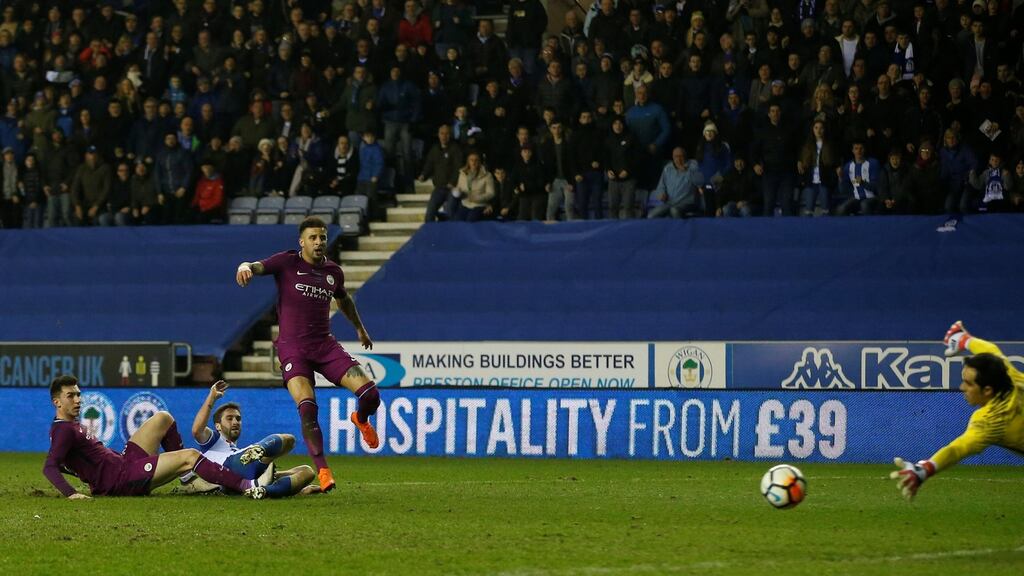 Will Grigg scores Wigan Athletic’s goal during the FA cup fifth round against Manchester City at DW Stadium. Photograph: Andrew Yates/Reuters