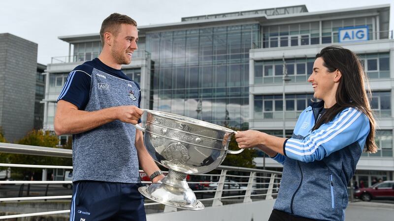 Dublin Footballer Paul Mannion and Ladies footballer Lyndsey Davey, along with the Sam Maguire and Brendan Martin Cups, were at AIG Insurance’s head office in Dublin on Tuesday to mark Dublin’s All-Ireland wins. Photograph: Sam Barnes/Sportsfile