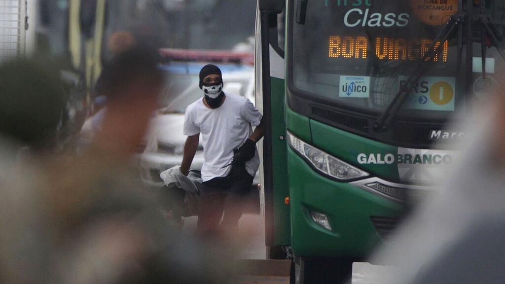 A man who hijacked a bus  with 37 passengers in Rio de Janeiro, before he was shot dead by police. Photograph: Photograph: Ricardo Cassiano/Agencia O Dia/AFP/Getty Images