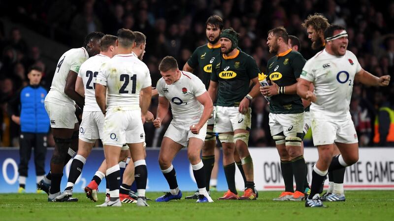 Farrell and England celebrate victory after the tackle was deemed to be fair. Photo: Mike Hewitt/Getty Images