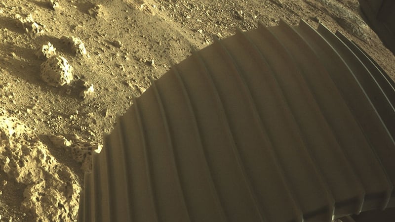 NASA handout high-resolution image showing one of the six wheels aboard NASA’s Perseverance Mars rover after it touched down on Mars on Thursday. Photograph: NASA/JPL-Caltech/PA Wire