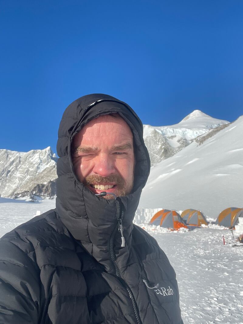 Rory McHugh at low camp with Mount Vinson summit in the background.