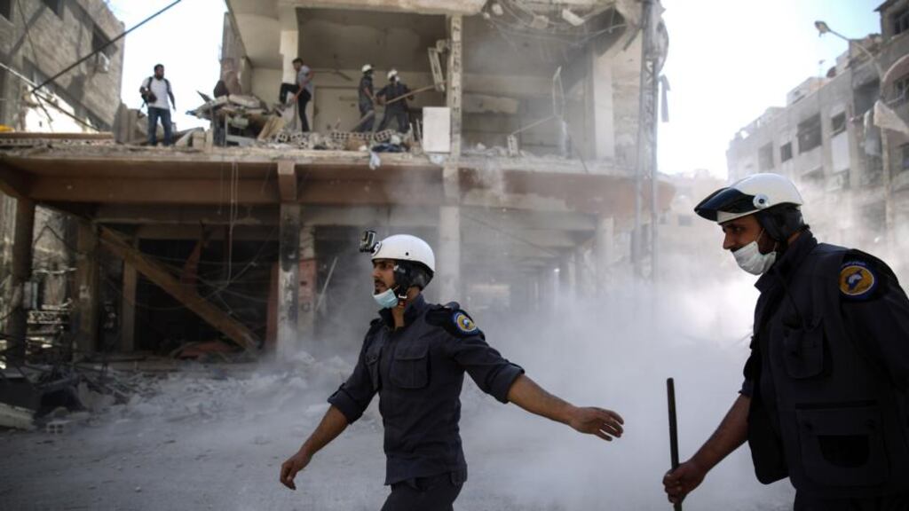 Members of the White Helmets work around destroyed buildings following air strikes in the town of Douma, Syria on October 5th 2016. Photograph: Sameer Al-Doumy/AFP/Getty