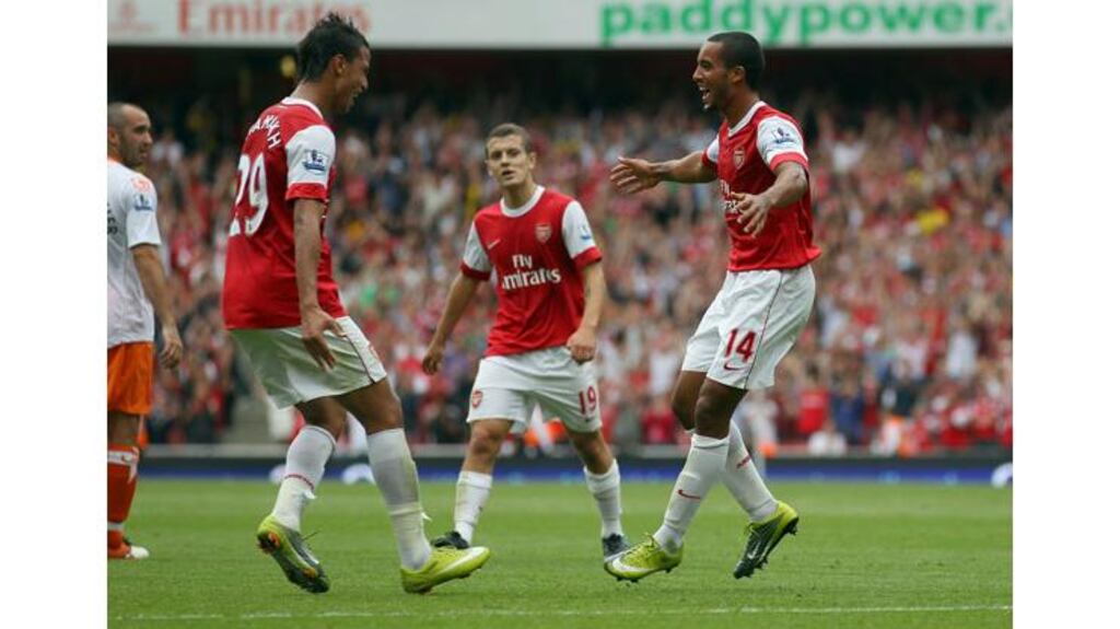 Theo Walcott (right) celebrates with Marouane Chamakh after scoring the first of his three goals against Blackpool at the Emirates Stadium. - (Photograph: Clive Rose/Getty Images)