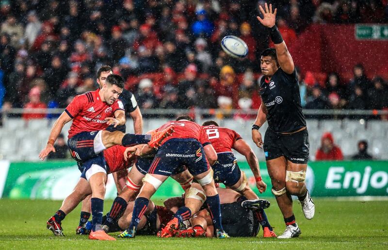 Conor Murray box-kicks through the torrential rain at Thomond Park. Photograph:  Gary Carr/Inpho