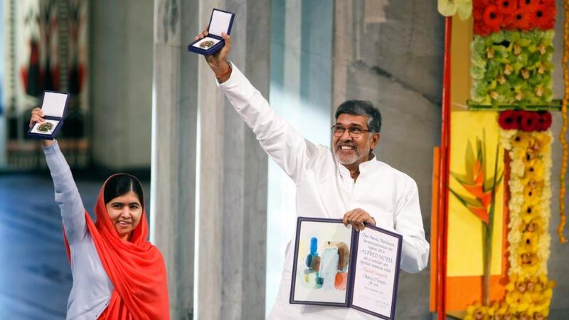 Laureates Malala Yousafzai and Kailash Satyarthi display their medals during the 2014 Nobel Peace Prize ceremony at Oslo City Hall in Norway. Photograph: Cornelius Poppe/EPA.