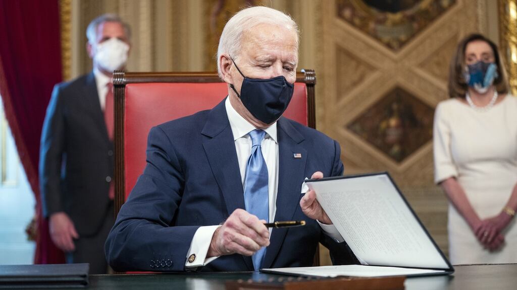 President Joe Biden signs documents in the President’s Room at the US Capitol after the inauguration ceremony on Wednesday. Photograph: Jim Lo Scalzo/Pool Photo via AP