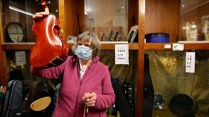 Maria Byrne checks a violin for one of her final customers. Photograph: Alan Betson/The Irish Times