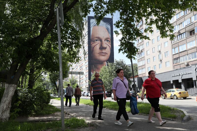 People walk past a mural depicting WikiLeaks founder Julian Assange on a wall of an apartment building in Balashikha, outside Moscow, on Tuesday. Photograph: Maxim Shipenkov/EPA-EFE