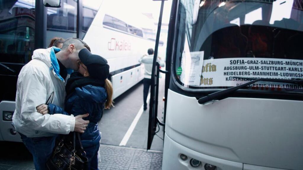 A couple kiss goodbye next to a bus departing from the  central bus station in the Bulgarian capital Sofia this morning for  London via Austria, Germany and France. Photograph: Stoyan Nenov/Bulgaria
