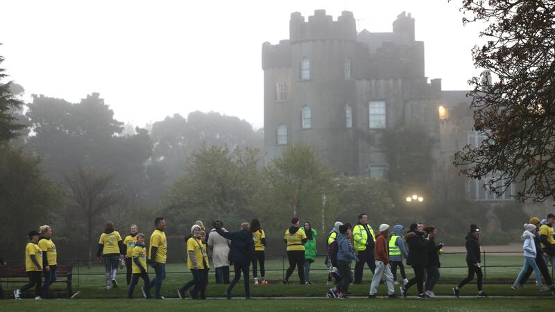 People pass Malahide Castle in Co Dublin as part of the Darkness Into Light walk this morning .Photograph: Dara Mac Dónaill/The Irish Times