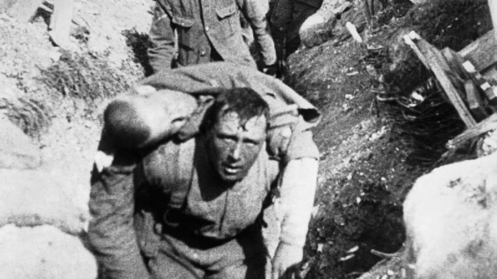 A frame from ‘The Battle of the Somme’ showing a soldier carrying a wounded comrade.