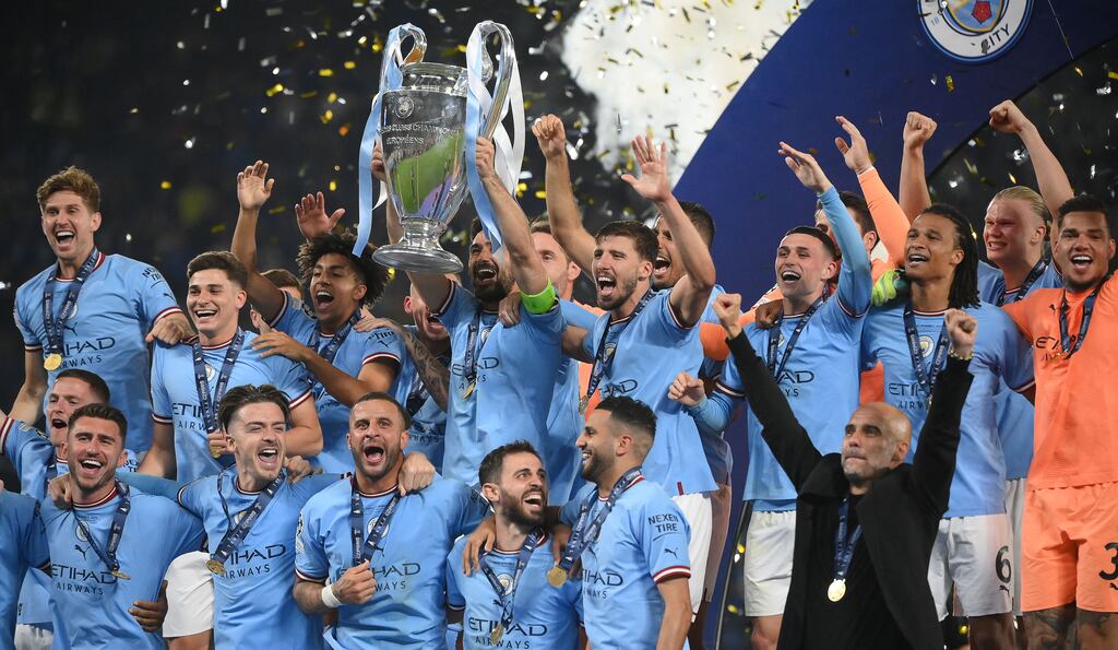 Manchester City teammates celebrate on the podium after winning the UEFA Champions League final against Inter Milan at the Ataturk Olympic Stadium in Istanbul, Turkey, on Saturday. Photograph: Franck Fife/AFP/Getty