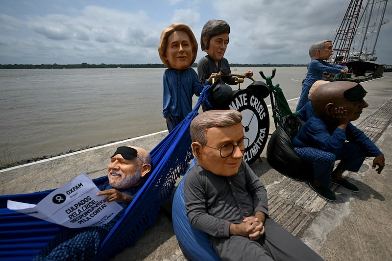 Oxfam activists wearing masks representing Luiz Inacio Lula da Silva, Keir Starmer, Ursula Von der Leyen, Javier Milei, Cyril Ramaphosa and Mark Carney during a protest in Belém, Brazil. Photograph: Mauro Pimentel/AFP via Getty