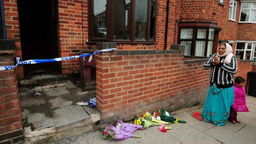 A local resident says a prayer outside the scene of the house fire in Wood Hill, Leicester, in which Shehnila Taufiq, her teenage sons Jamal and Bilal and daughter Zainab died. Photograph: Rui Vieira/PA Wire