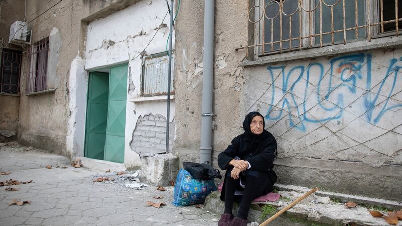 An 85-year old woman waits for her relatives to leave from her damaged house in Durres. Photograph: Petros Giannakouris/AP Photo