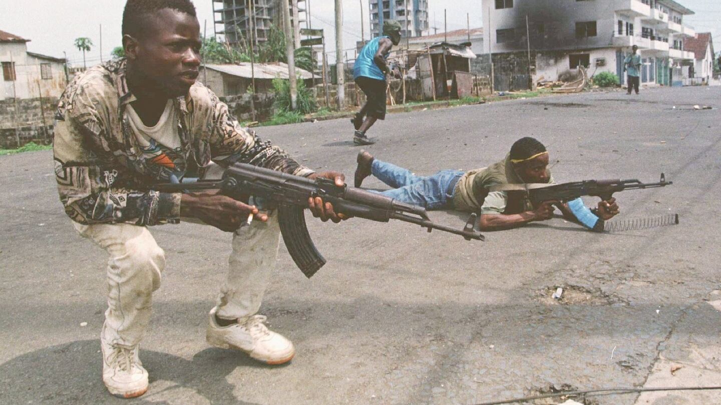 Liberian street fighters allied with warlord Charles Taylor fire on advancing troops from rival militias. Photograph: Corinne Dufka/Reuters