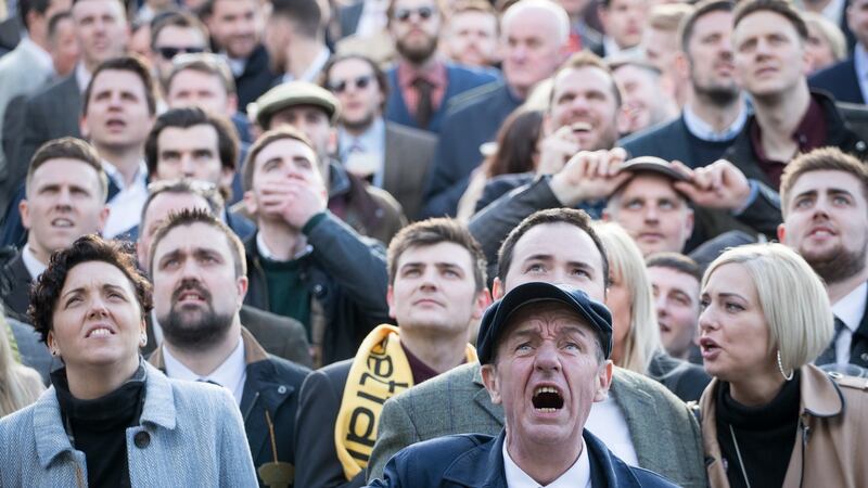 Racegoers watch the St James’s Place Foxhunter Steeple Chase Challenge Cup at Cheltenham. Photograph: Matt Cardy/Getty Images