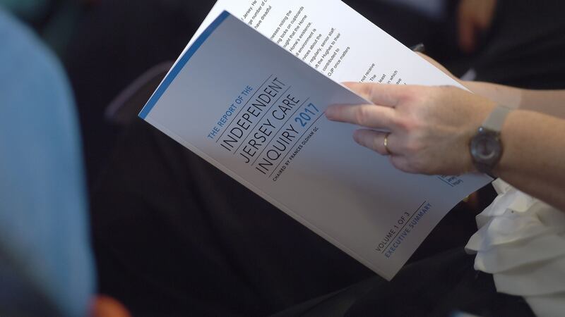 A person looks at a copy of the Independent Jersey Care Inquiry report into historical child abuse during a press conference at St Paul’s Centre, St Helier. Photograph: Lauren Hurley/PA Wire