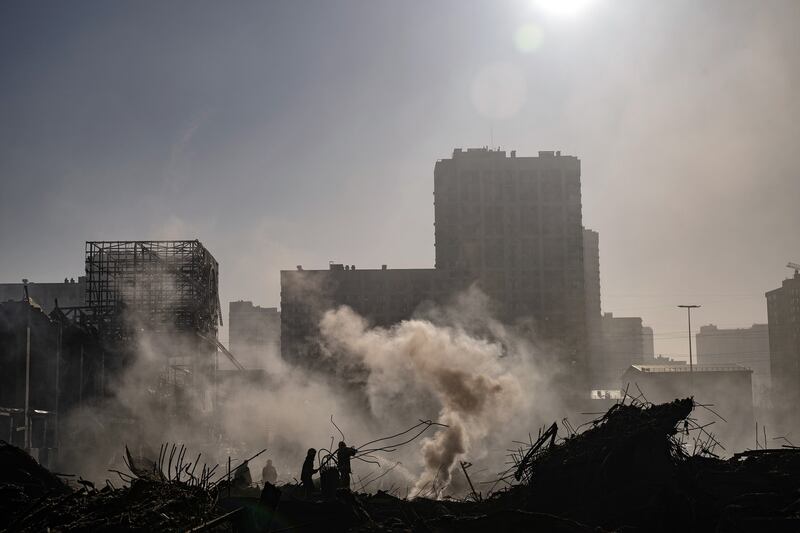 Firefighters and rescue workers on the scene after a Russian missile strike reduced a sprawling shopping mall in Kyiv to a smoldering ruin on Monday. Photograph: Lynsey Addario/The New York Times