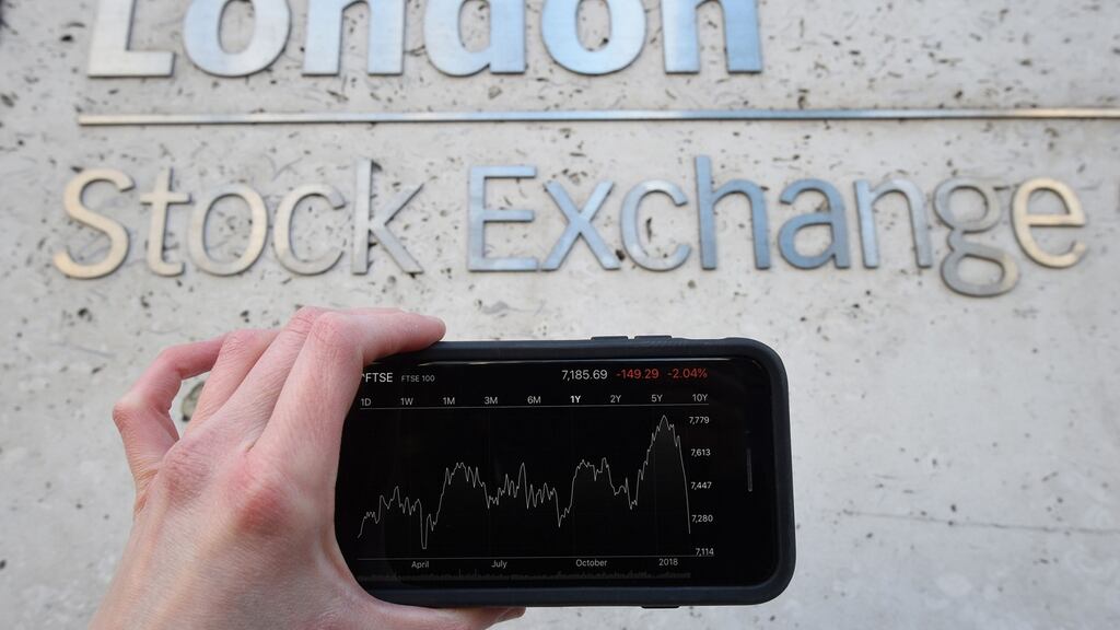 A view of the Stocks app on an iPhone against the London Stock Exchange sign in the City of London. Photograph: Kirsty O’Connor/PA Wire