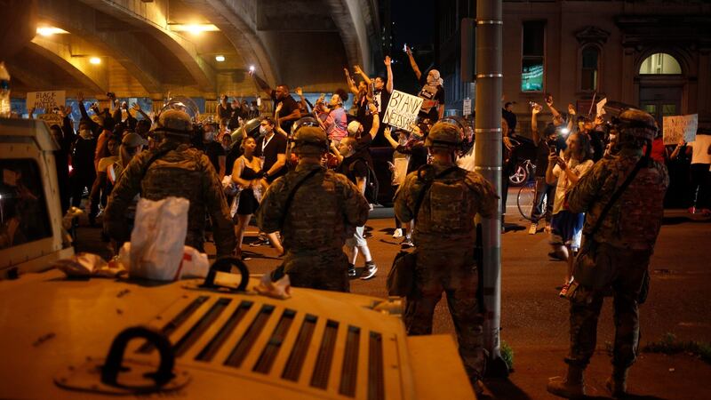Members of the national guard stand watch in Louisville, as people violate curfew to demonstrate against the deaths of Breonna Taylor and David McAtee, both of whom were shot and killed by local law enforcement. Photograph: Luke Sharrett/New York Times