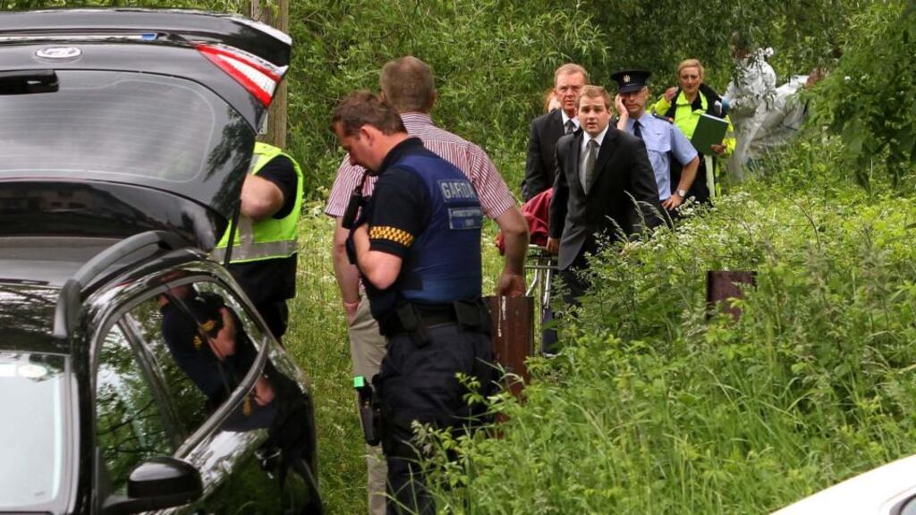 The body of a woman discovered at Kileely, Co Limerick, being removed from the scene. Photograph: Tony Grehan/Press 22