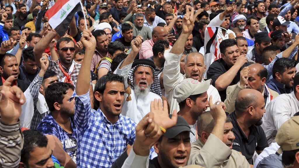 Followers of Shiite cleric Muqtada al-Sadr protest outside the heavily guarded Green Zone in Baghdad, Iraq on Friday. Thousands have rallied in Baghdad in support of al-Sadr who has taken the lead role in protests demanding government reforms. Photograph: Karim Kadim/AP