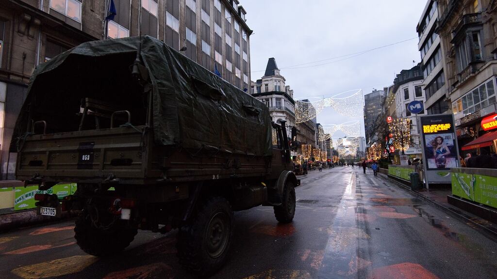 An armoured car drives along the street in Brussels, Belgium. The city has witnessed the biggest presence of armed forces since the second World War Photograph: Ben Pruchnie/Getty Images