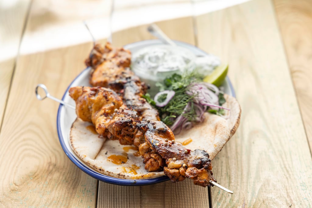 Barbecue chicken swarma with flatbread and tzaziki. Photograph: Harry Weir
