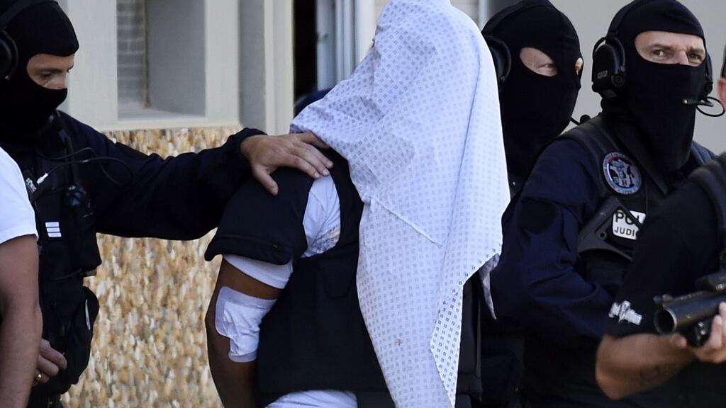 Yassin Salhi, who was suspected of decapitating his boss, is escorted from his apartment in Saint-Priest, Lyon, in June. Photograph: Philippe Desmazes/AFP/Getty Images