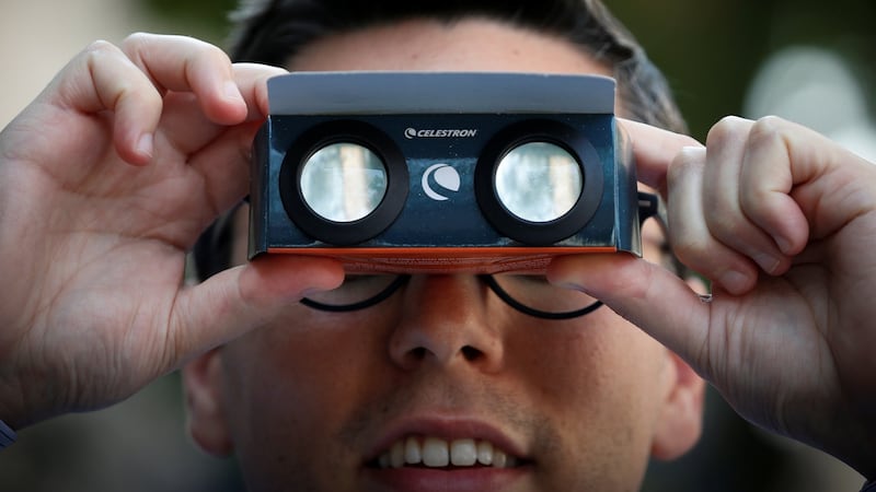 A man looks through solar viewing glasses to watch the total solar eclipse in New York City, US. Photograph: Brendan McDermid/Reuters