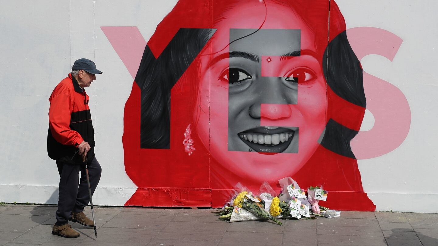 People pass a mural of Savita Halappanavar in Dublin, as polls open for the referendum on the Eighth Amendment. Photograph: Niall Carson/PA Wire