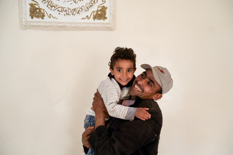 Nabil playing with his son Mohammed who has recovered from cholera. Photograph: Alsunaidar/Unicef