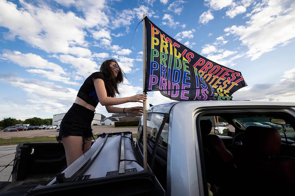 Hillary Ward puts up a Pride flag while protesting near Stedfast Baptist Church, where a pastor preaches against homosexuality, on June 1st, 2022, in Watauga, Texas. The platform adopted by Republicans in Texas would urge treating homosexuality as “an abnormal lifestyle choice”. Photograph: Yffy Yossifor/Fort Worth Star-Telegram/Tribune News Service via Getty Images