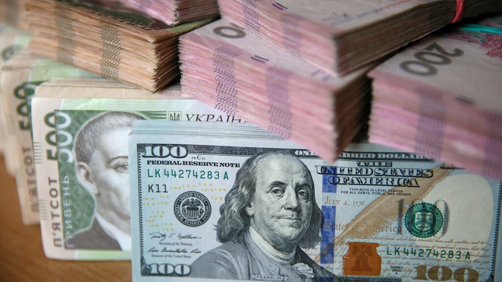 Dollars and Ukrainian hryvhia banknotes: Roman Nasirov, who leads Ukraine’s tax service, declared several Kiev apartments and cash holdings with his wife of almost €2 million. His official salary for 2015, the Kyiv Post reports, was about €1,300. Photograph: Valentyn Ogirenko/Reuters