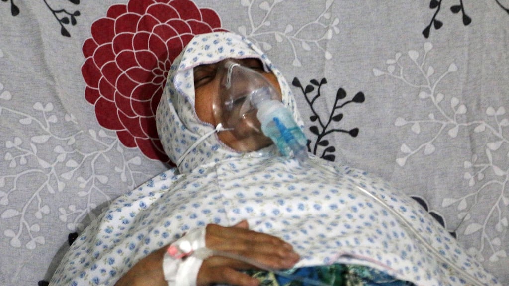 A woman breathes through an oxygen mask at al-Quds hospital in Syria, after a hospital and a civil defence group said a gas,  believed to be chlorine, was dropped alongside barrel bombs on a neighbourhood in Aleppo. Photograph: Abdalrhman Ismail/Reuters