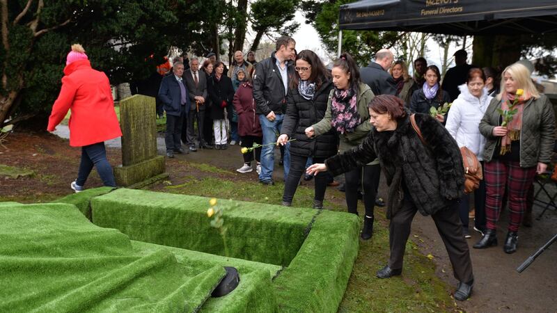 People toss flowers into Margaret Lang’s grave at her funeral in Trim, Co Meath on Thursday. Photograph: Alan Betson/The Irish Times