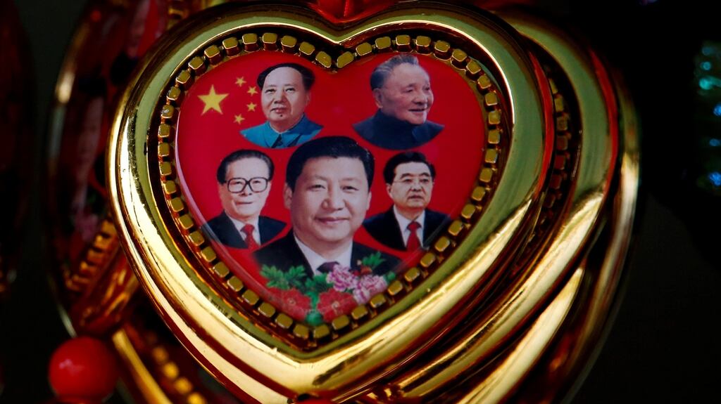 A souvenir featuring portraits of former Chinese leaders Mao Zedong, Deng Xiaoping, Jiang Zemin, Hu Jintao and current president Xi Jinping is sold on Tiananmen Square on the second day of plenary sessions. Photograph: Thomas Peter/Reuters