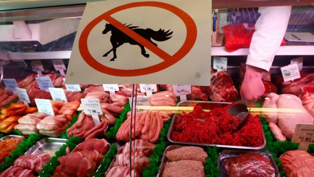 A butcher works behind a “no horsemeat” sign in Market Harborough, central England. Photograph: Reuters