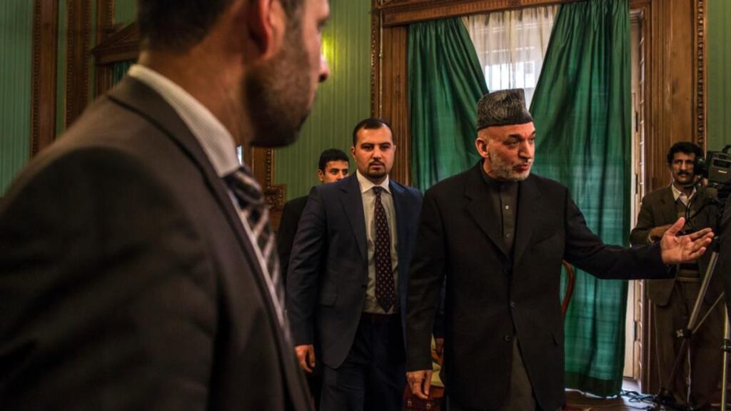 Afghanistan’s president Hamid Karzai greets reporters as he arrives at a news conference at the presidential palace in Kabul. Mr Karzai has engaged in secret contacts with the Taliban without the involvement of his American and Western allies, further corroding already strained relations with the United States as they try to reach a peace agreement. Photograph: Mauricio Lima/The New York Times