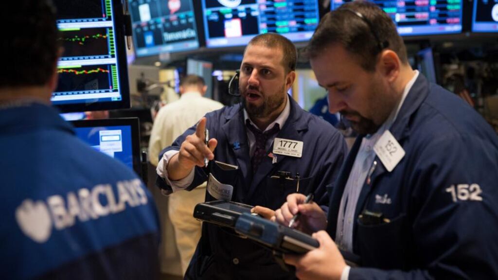 Traders work on the floor of the New York Stock Exchange yesterday. Expectations of an early move by the US Federal Reserve to slow its support for the US economy firmed yesterday. Photograph: Scott Eells/Bloomberg